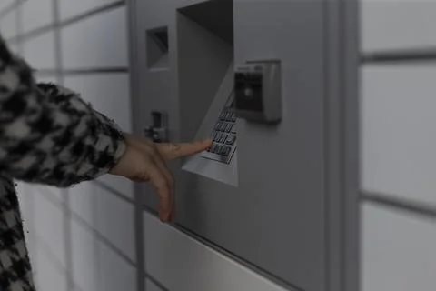 A person is pressing a button on a specific machine or device Stock Photos
