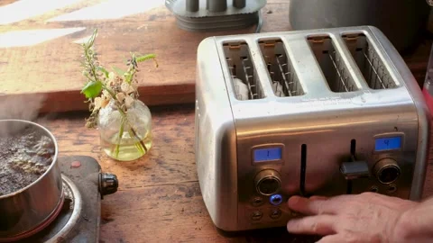 Person Pressing Button on Toaster to Start Toasting Stock Footage 337119767