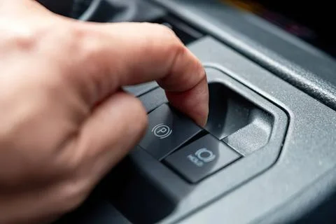 Person pressing a car start button in a vehicle interior Stock Photos