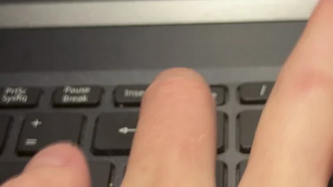 Person pressing delete button with force on laptop or computer keyboard Stock Footage 310490959