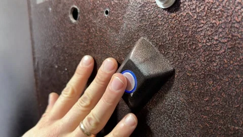 Person pressing door opening button on intercom panel close up outdoors, Stock Footage 337104640