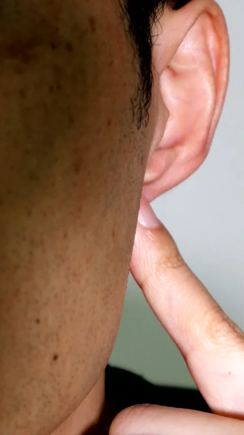 A person pressing on ear pressure points Stock Footage 334638602