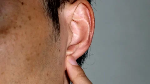 A person pressing on ear pressure points Stock Footage 334643089