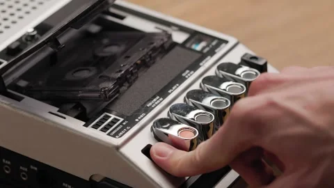 Person pressing eject button on vintage cassette recorder Stock Footage 302969566