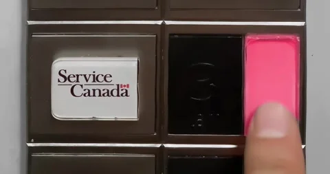 A person is pressing the elevator button to access a Service Canada Government Stock Footage 250197505