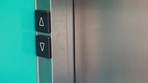 Person pressing elevator call button in modern residential building. Everyday Stock Footage 346397420
