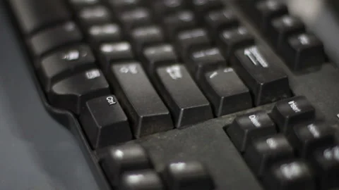 Person pressing the enter button on a black computer keyboard Stock Footage 152922083
