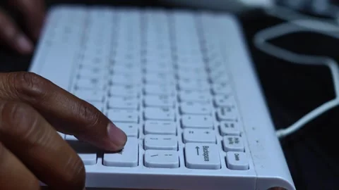 Person pressing the enter key on a computer keyboard Stock Footage 345550347