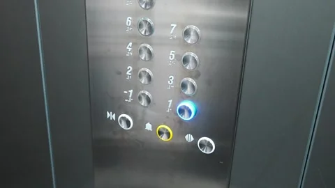 Person pressing the first floor button inside a modern residential elevator Stock Footage 346396971