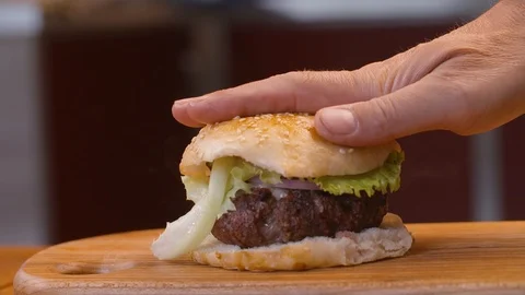 Person pressing hamburger Stock Footage 85813031