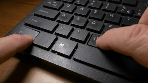 Person pressing the keys to do the copy paste commands on a keyboard Stock Footage 229554913