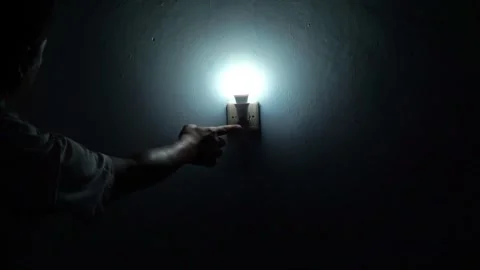 Person pressing a light switch to turn on illumination indoors. Stock Footage 336769006