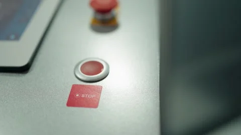 Person pressing a red stop button on a control panel Stock Footage 342741080