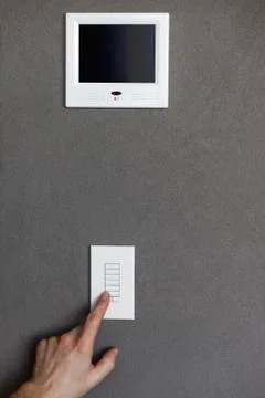 Person pressing switches of a security camera control panel Stock Photos