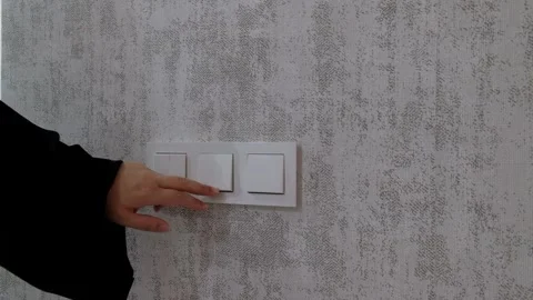 Person Pressing Wall Light Switch to Turn On the Lights Home Lighting Control Video stock 302687947