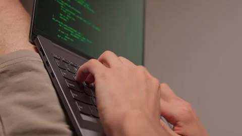 Person programming on laptop with relaxed posture and soft lighting. Individuals Stock Footage 346244597
