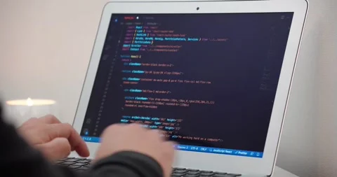 A person programming on a laptop, showing lines of code on the screen Stock Footage 318928224