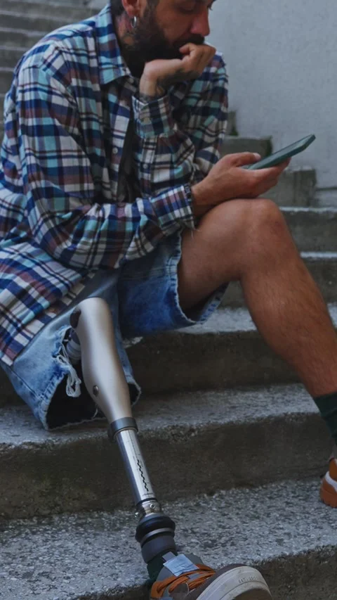 Person with prosthetic leg navigating steps in urban setting Stock Footage 291962268