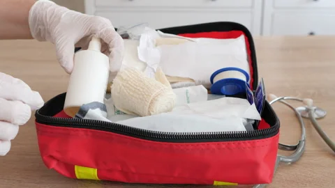 Person in protective gloves opens first aid kit Stock Footage 146698185