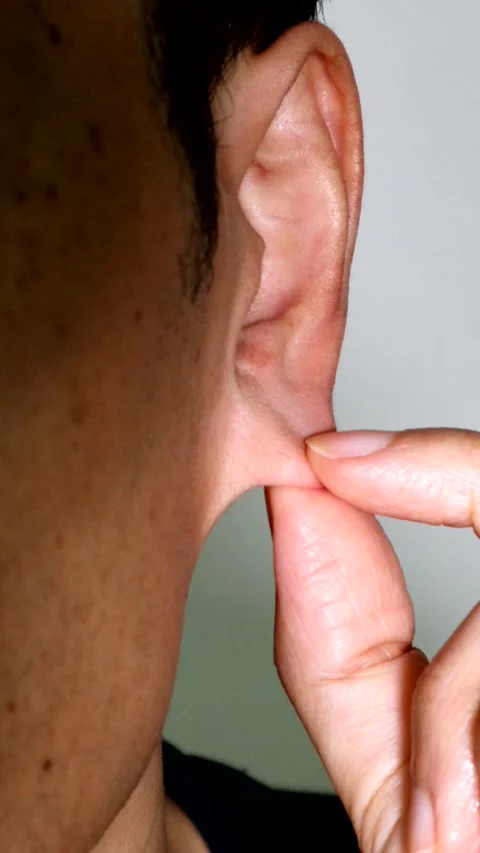 A person pulling on an earlobe Stock Footage 334638816