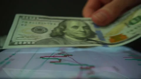 Person puting one hundred dollar bills on digital exchange on tablet screen Stock Footage 233900744