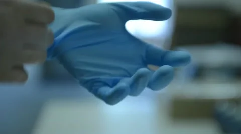 Person Puts On Blue Gloves 스톡 동영상 66365656