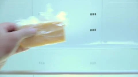 A person puts in an empty fridge piece of hard cheese, poverty, single, close-up Stock Footage 67717684