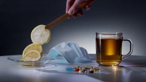 Person puts a lemon slice in tea to make a drink to boost the immune system Video stock 142450100