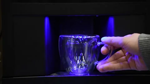 Person putting empty cup in coffee machine Stock Footage 304082174