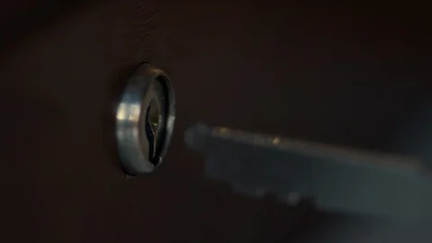 Person putting key into keyhole Stock Footage