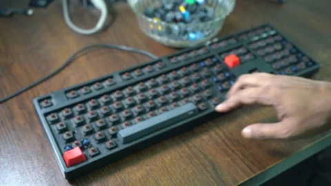 A person putting the keys in their mechanical keyboard with their fingers Stock Footage 161326053