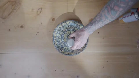 A person is putting something on a plate Stock Footage 306043908