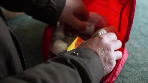 A person quickly searching through a first aid kit Stock Footage 151490594