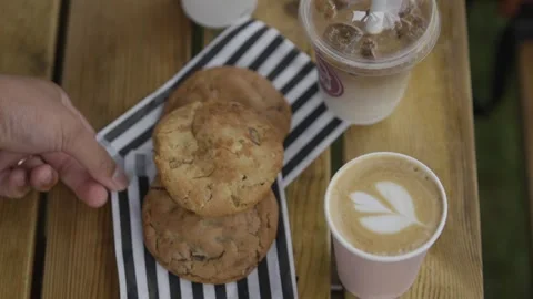 A person is reaching for a cookie on a plate Stock Footage 301629316