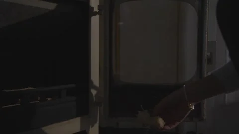 A person is reaching into an oven Stock Footage 302471562