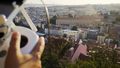 Person with remote control using drone flying above roofs of buildings in city Stock Footage 104680210