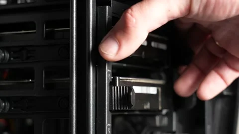 Person removes and inserts old dusty hdd (hard drive disks) into computer case Stock Footage 154313227