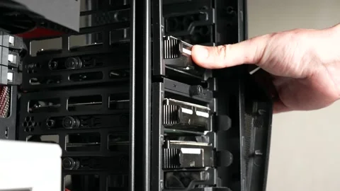 Person removes and inserts old dusty hdd (hard drive disks) into computer case Stock Footage 154313245