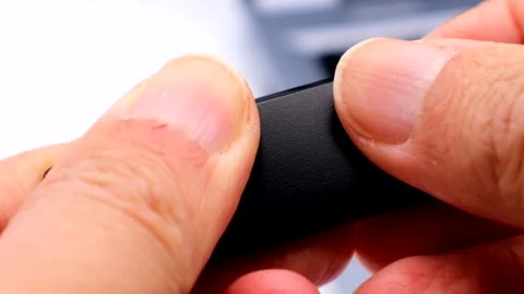 A person removing the cap from a USB memory stick. Stock Footage 335269055