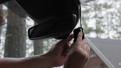 A person removing a memory card from a dash camera. Horizontal slow-motion. Stock Footage 341361323