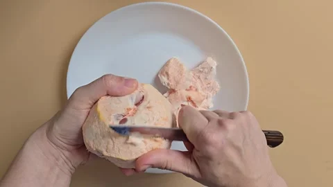 A person removing the white pith from a grapefruit with a knife in front of.. Stock Footage 342028094
