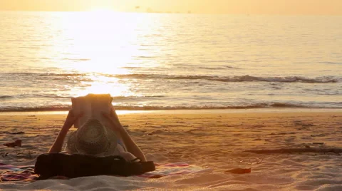 Person Resting on the Beach with Book Stock Footage 62420590