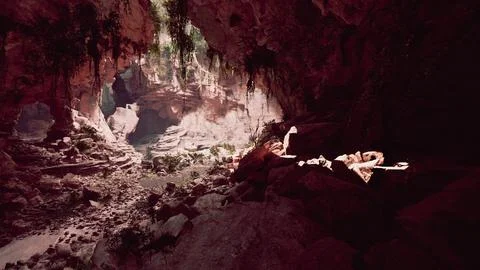 A person resting on a rocky surface inside a cave Illustrazione stock