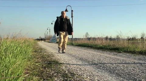 Person returns home through the path in the countryside Stock Footage 48843448