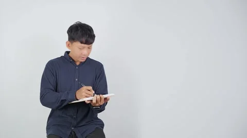 Person Reviewing Work While Reading Document 動画素材 344830771