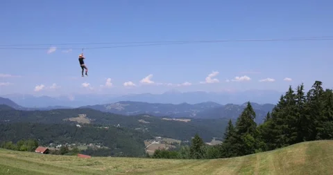 Person riding with zip line, Stari vrh mountain, Skofia-Loka mountains, Julian Stock Footage 342187975