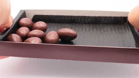 A person rolling almond chocolates Stock Footage 336620495