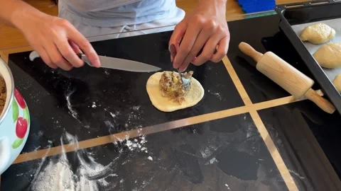Person rolling dough on table with rolling pin for a recipe Stock Footage 287602640