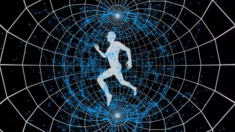 A person rotates between two poles of space in which small particles fly Stock Footage 247823814