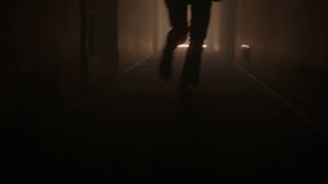 Person Running Down A Dark Hallway | Stock Video | Pond5